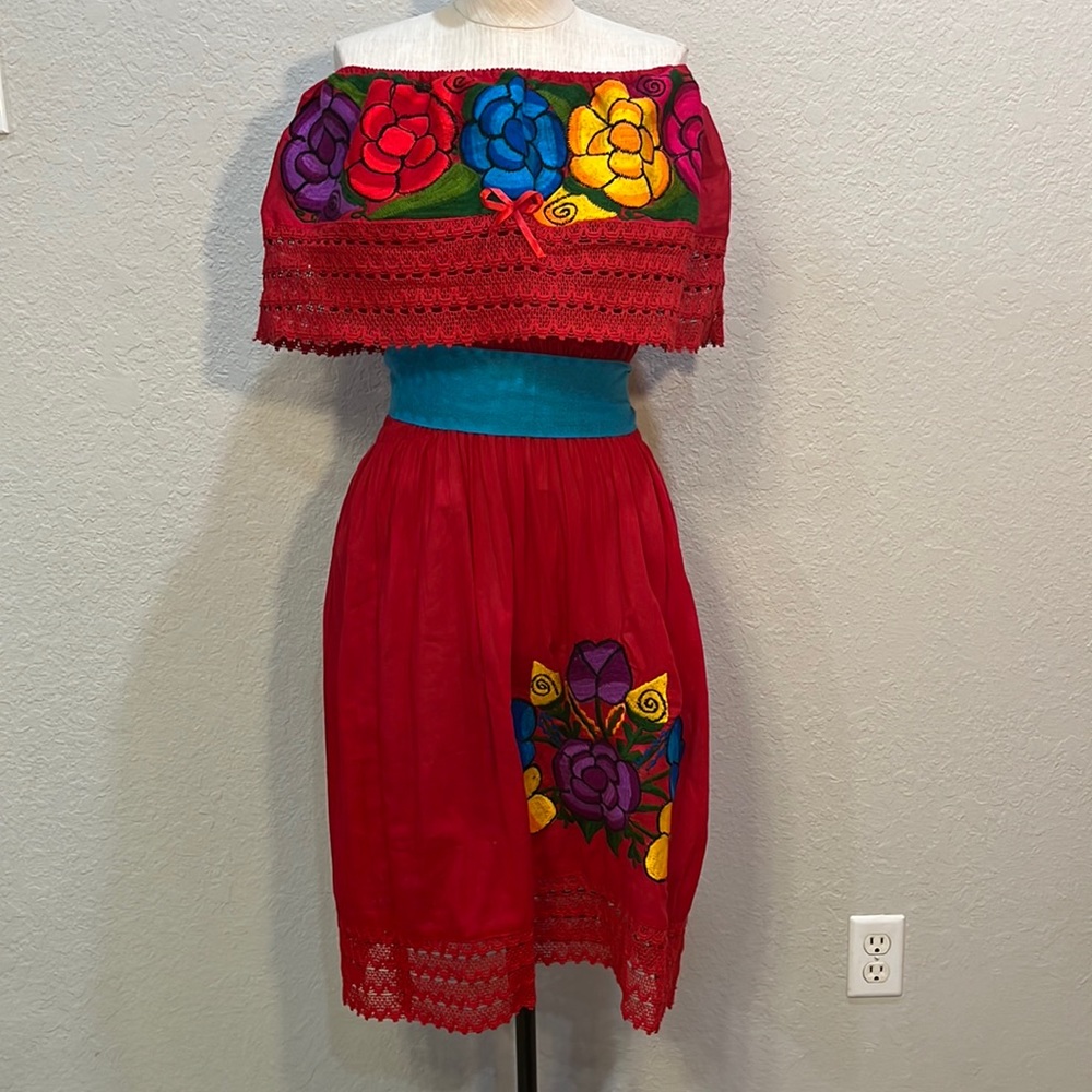 Beautiful colorful Mexican dress with vibrant colorful flowers.